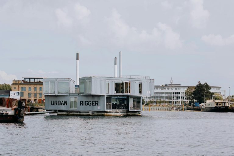 Modern floating dormitory in Copenhagen harbor, showcasing innovative urban architecture.