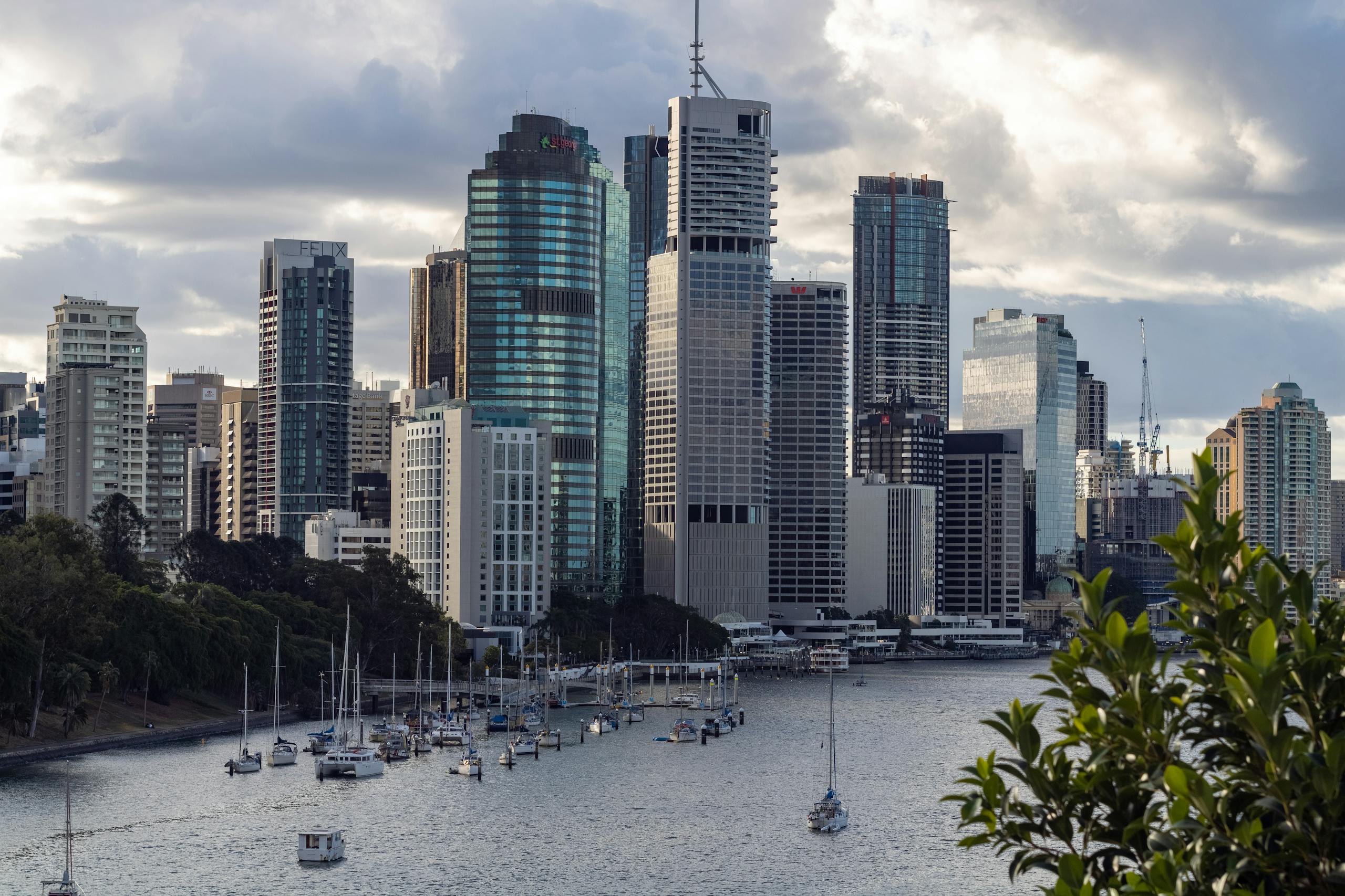 Scenic view of Brisbane skyline from Kangaroo Point with boats on the Brisbane River.
